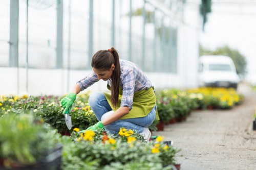 Safety-focused landscaper planning work on a residential garden site